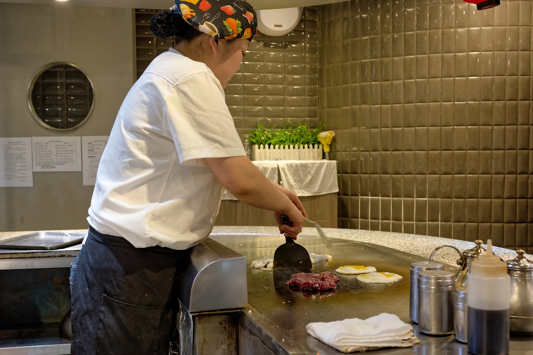 Professional kitchen with multiple cooking stations and chefs working